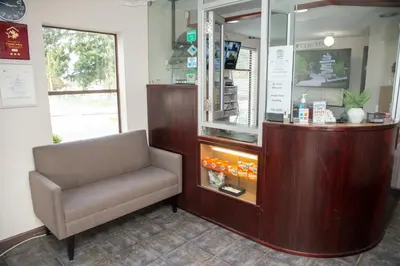 a waiting room with a chair in a store at Happy Day Inn in Burnaby