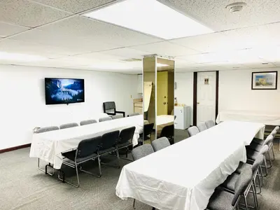 a conference room with white tables and chairs at Happy Day Inn in Burnaby