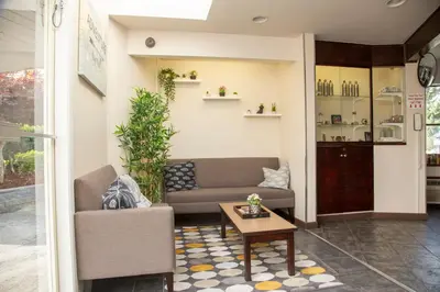 a living room with a couch and a table at Happy Day Inn in Burnaby