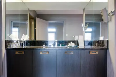 a bathroom with a sink and a mirror at Hotel Arts Kensington in Calgary