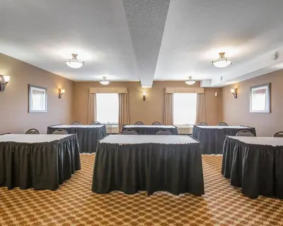 a conference room with tables and chairs in it at Comfort Inn & Suites in Airdrie