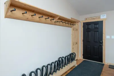 a gymnasium with a black door and a row of black chairs at Mama Bear in Valemount