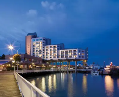 a city skyline with a marina at night at Inn At The Quay in New Westminster
