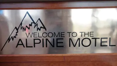 a sign that says welcome to the alpine motel at Alpine Motel in Kamloops