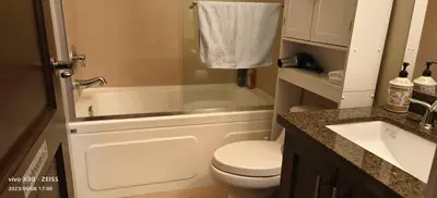 a bathroom with a toilet and a tub and a sink at Sunny Island by White Rock B&B in White Rock