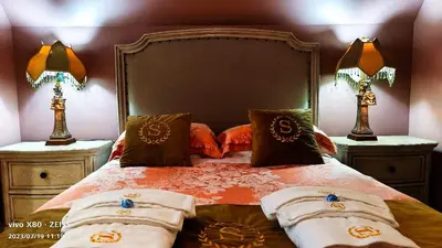 a bedroom with a bed with two nightstands and two lamps at Sunny Island by White Rock B&B in White Rock