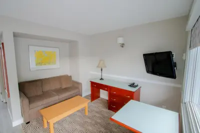 a living room with a couch and a tv at Scott's Inn & Suites in Kamloops