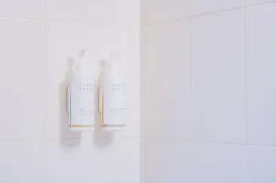 a group of three white bottles on a shelf at Scott's Inn & Suites in Kamloops