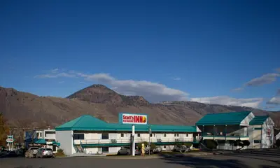 a gas station with mountains in the background at Scott's Inn & Suites in Kamloops