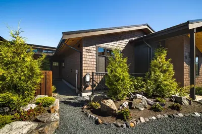 a house with a garden in front of it at Avatar by Eagle Reach Properties in Port Renfrew