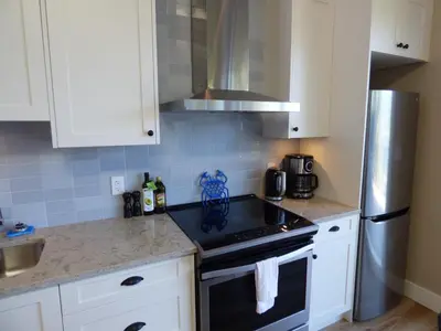 a kitchen with a stove and a refrigerator at Avatar by Eagle Reach Properties in Port Renfrew