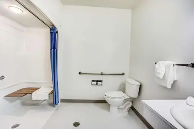 a bathroom with a toilet and a sink at Motel 6-Red Deer, AB in Red Deer