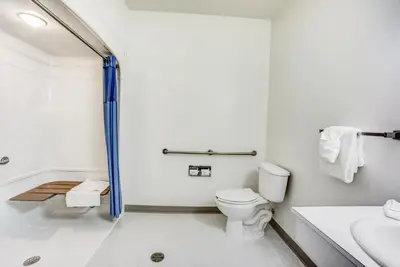 a bathroom with a shower and a toilet and a sink at Motel 6-Red Deer, AB in Red Deer