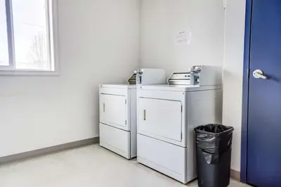 a laundry room with two washer and dryer at Motel 6-Red Deer, AB in Red Deer