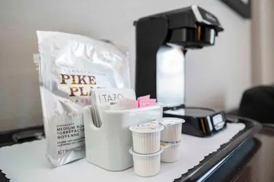 a coffee maker and some cups on a counter at Sandman Signature Prince George Hotel in Prince George