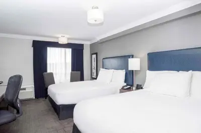 a hotel room with two beds and a window at Sandman Signature Prince George Hotel in Prince George