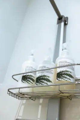 a rack with bottles of detergent on a shelf at The Cube Cow Bay Suite in Cowichan Bay
