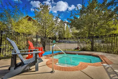 a swimming pool with two chairs and a slide at Timberline Lodge by StayIn in Fernie