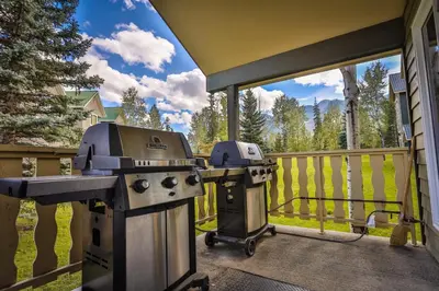 a grill and smoker on a deck on a porch at Timberline Lodge by StayIn in Fernie
