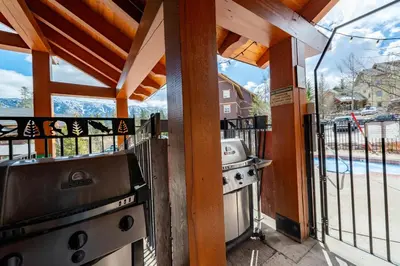 a outdoor kitchen with a grill and a stove at Timberline Lodge by StayIn in Fernie