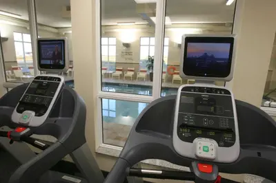 three cell phones on a treadmill in a gym at Hampton Inn & Suites Red Deer in Red Deer