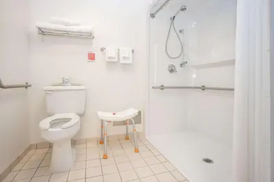 a white bathroom with a toilet and a shower at Ramada by Wyndham Surrey/Langley in Surrey