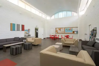 a living room with couches and chairs and a table at HI Edmonton - Hostel in Edmonton