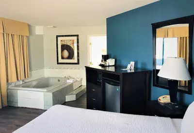 a large bathroom with a tub and a bed at Days Inn by Wyndham Kamloops BC in Kamloops