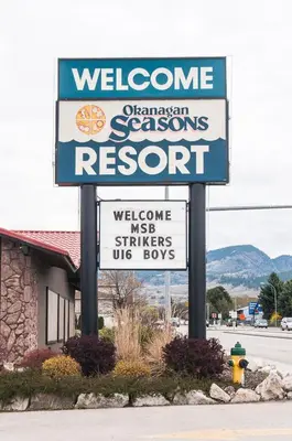 a welcome sign in front of a store at Okanagan Seasons Resort in Kelowna