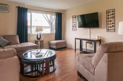 a living room with a couch and a tv at Okanagan Seasons Resort in Kelowna
