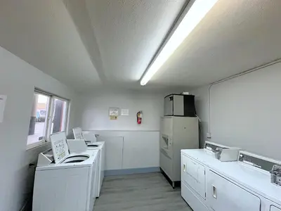 a kitchen with white appliances and a refrigerator at Okanagan Seasons Resort in Kelowna