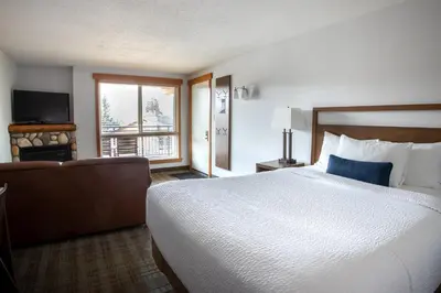 a hotel room with a large bed and a window at Pyramid Lake Lodge in Jasper