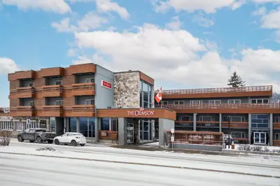 a building on a street with a car parked in front at The Crimson Jasper in Jasper
