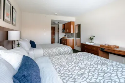 a hotel room with two beds and a kitchen at The Crimson Jasper in Jasper