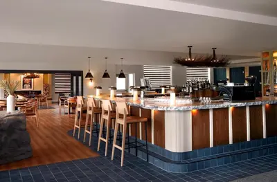 a kitchen and dining room with a bar with stools at The Crimson Jasper in Jasper