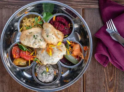 a plate of food on a wooden table at Spirit Ridge, in The Unbound Collection by Hyatt in Osoyoos