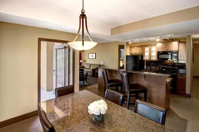a kitchen and dining room with a table and chairs at Spirit Ridge, in The Unbound Collection by Hyatt in Osoyoos