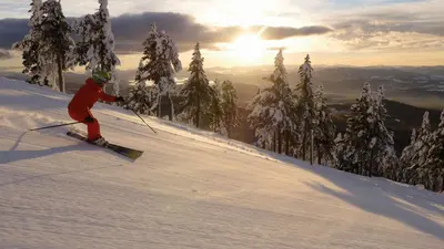 a person is skiing down a snow covered slope at Spirit Ridge, in The Unbound Collection by Hyatt in Osoyoos