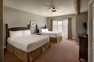 a hotel room with two beds and a flat screen tv at Spirit Ridge, in The Unbound Collection by Hyatt in Osoyoos