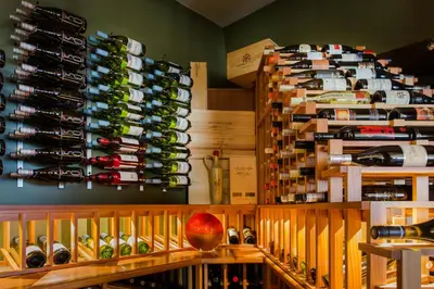 a room filled with lots of bottles of wine at Astoria Hotel in Jasper