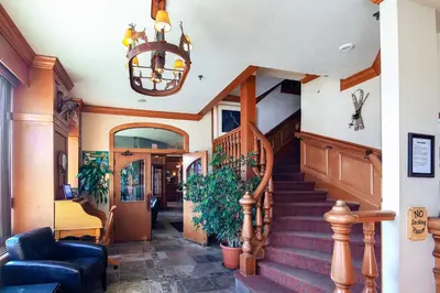 a staircase in a home with a chandelier at Astoria Hotel in Jasper