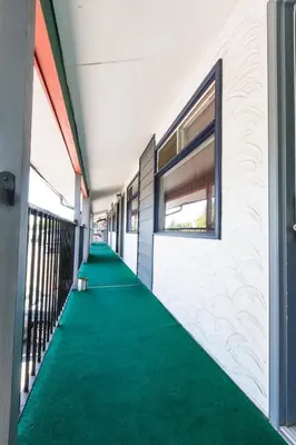 a hallway with a green carpet in a building at Grandview Motel in Kamloops
