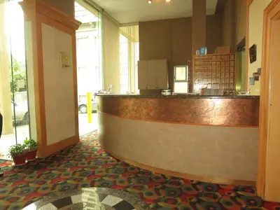 a bar in a restaurant with a counter at Tropicana Suite Hotel in Vancouver