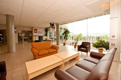 a lobby with a couch and chairs and a table at Residence & Conference Centre - Kamloops in Kamloops