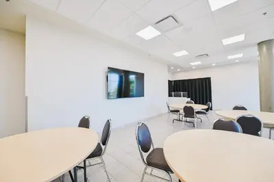 a classroom with tables and chairs in a room at Residence & Conference Centre - Kamloops in Kamloops