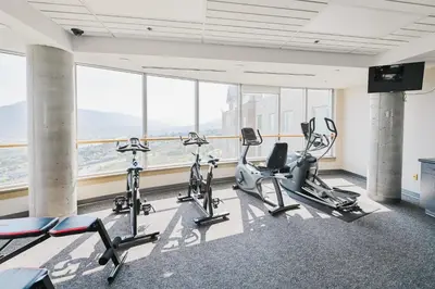 a gym with cardio equipment in a building with windows at Residence & Conference Centre - Kamloops in Kamloops