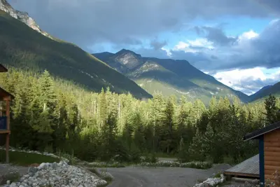 a view of a forest of trees and mountains at Glenogle Mountain Lodge and Spa in Golden