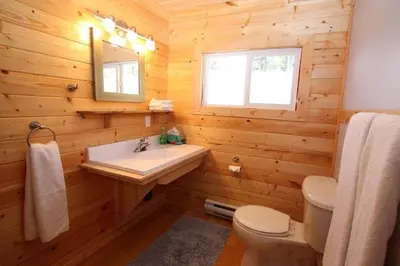a wooden bathroom with a sink and a toilet at Glenogle Mountain Lodge and Spa in Golden