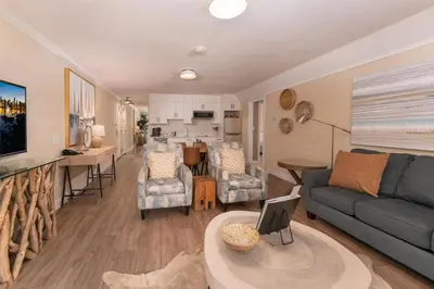 a living room with a couch and a table at Prestige Beach House, WorldHotels Crafted in Kelowna