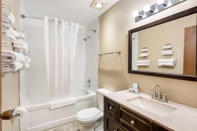 a bathroom with a sink and a toilet and a tub at Days Inn by Wyndham Nanaimo in Nanaimo